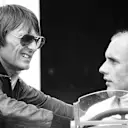 Seen here chatting with Brabham team owner Bernie Ecclestone at Silverstone, Stuck finished the 1977 British Grand Prix in fifth place