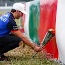 SUZUKA, JAPAN - OCTOBER 04: Pierre Gasly, Scuderia Toro Rosso, lays flowers in memory of Jules Bianchi during the Japanese GP at Suzuka on October 04, 2018 in Suzuka, Japan. (Photo by Andy Hone / LAT Images)