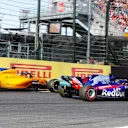 SUZUKA, JAPAN - OCTOBER 07: Fernando Alonso, McLaren MCL33, runs off the track behind Brendon Hartley, Toro Rosso STR13 Honda during the Japanese GP at Suzuka on October 07, 2018 in Suzuka, Japan. (Photo by Steven Tee / LAT Images)