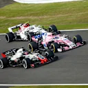 SUZUKA, JAPAN - OCTOBER 07: Romain Grosjean, Haas F1 Team VF-18, battles with Sergio Perez, Racing Point Force India VJM11 and Charles Leclerc, Sauber C37 Ferrari during the Japanese GP at Suzuka on October 07, 2018 in Suzuka, Japan. (Photo by Andy Hone / LAT Images)