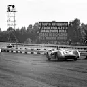 Race winner Juan Manuel Fangio leads Strirling Moss (both stream-lined Mercedes-Benz W196) come off the Curva Sud in the 1955 race. Note the armco barrier denoting the inside and outside lanes of the main straight. World copyright: LAT Photographic