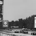 Four Ferrari Dino 156s race down the outside lane of the main straight in the 1961 race. Note the banking in the background, as well as the cones which divided the straight in two. World Copyright: LAT Photographic