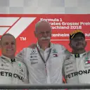 The iconic whiskers in between Valtteri Bottas and Lewis Hamilton belong to Dr. Dieter Zetsche, Chairman of the Board of Management of Daimler AG and Head of Mercedes-Benz Cars