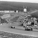 Carel Godin de Beaufort (Porsche 718) leads a Ferrari Dino 156 passed the pits towards Eau Rouge. 1962 Belgian Grand Prix. © LAT Photographic