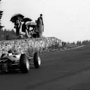 Despite the poor weather, a group of spectators have an unparalleled view of the action at the top of Eau Rouge. Note the stone wall. Belgian Grand Prix, Spa-Francorchamps, 9 June 1963. ©Sutton Motorsport Images