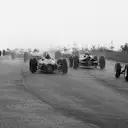 The competitors climb through Eau Rouge in tricky wet conditions at the start; a keen photographer on the right getting very close to the action.
Belgian Grand Prix, Spa-Francorchamps, 9 June 1963.
©Sutton Motorsport Images