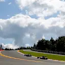 Jenson Button (GBR) McLaren MP4-29 leads Nico Rosberg (GER) Mercedes AMG F1 W05 through Eau Rouge in 2014. © Sutton Motorsport Images