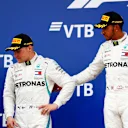 SOCHI AUTODROM, RUSSIAN FEDERATION - SEPTEMBER 30: Lewis Hamilton, Mercedes AMG F1, 1st position, consoles team mate Valtteri Bottas, Mercedes AMG F1, 2nd position, on the podium during the Russian GP at Sochi Autodrom on September 30, 2018 in Sochi Autodrom, Russian Federation. (Photo by Sam Bloxham / LAT Images)