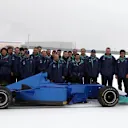 Sauber team members grit their teeth as they brave the icy conditions to display the brand new Sauber C22 at a snowy Fiorano in January 2003. © Sutton Motorsport Images