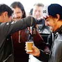 CIRCUIT OF THE AMERICAS, UNITED STATES OF AMERICA - OCTOBER 19: Lando Norris, McLaren, stirs a cup of tea with a power tool for Fernando Alonso, McLaren, as IndyCar driver JR Hildebrand watches in the garage during the United States GP at Circuit of the Americas on October 19, 2018 in Circuit of the Americas, United States of America. (Photo by Steven Tee / LAT Images)