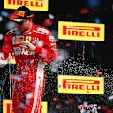 CIRCUIT OF THE AMERICAS, UNITED STATES OF AMERICA - OCTOBER 21: Kimi Raikkonen, Ferrari, 1st position, celebrates with Champagne on the podium during the United States GP at Circuit of the Americas on October 21, 2018 in Circuit of the Americas, United States of America. (Photo by Andy Hone / LAT Images)