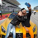 CIRCUIT OF THE AMERICAS, UNITED STATES OF AMERICA - OCTOBER 21: Lewis Hamilton, Mercedes AMG F1, takes a photo with actress Millie Bobby Brown during the United States GP at Circuit of the Americas on October 21, 2018 in Circuit of the Americas, United States of America. (Photo by Steve Etherington / LAT Images)