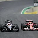 Jenson Button (GBR) McLaren MP4-29 and Kimi Raikkonen (FIN) Ferrari F14 T battle. Formula One World Championship, Rd18, Brazilian Grand Prix, Race, Sao Paulo, Brazil, Sunday, 9 November 2014