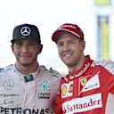 Race winner Lewis Hamilton (GBR) Mercedes AMG F1 and Sebastian Vettel (GER) Ferrari celebrate on the podium with the trophies at Formula One World Championship, Rd14, Japanese Grand Prix, Race, Suzuka, Japan, Sunday 27 September 2015. © Sutton Motorsport Images