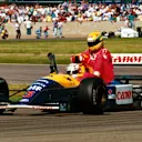 Race winner Nigel Mansell (GBR) Williams FW14 carries back to the pits fourth place finisher Ayrton Senna (BRA) McLaren, who ran out of fuel on the final lap.

British Grand Prix, Silverstone, England, 14 July 1991. © Sutton Motorsport Images