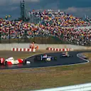 Eddie Irvine (middle car) unlapped himself from Ayrton Senna (rear car) going into Suzuka's famous chicane. © LAT Photographic