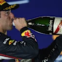 A sweaty Daniel Ricciardo re-hydrates on the podium with the help of some champagne. Singapore 2014. © Sutton Motorsport Images