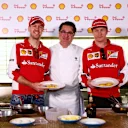 Sebastian Vettel and Kimi Raikkonen pose with chef Guy Grossi in the kitchen of the Merchant Restaurant during a Shell media event on March 12, 2015 in Melbourne, Australia.  © 2015 Getty Images