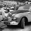 Stirling Moss makes some alterations to his stately Sunbeam-Talbot Alpine during the 1954 Monte Carlo Rally