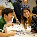 Kamui Kobayashi (JPN) Caterham with a fan in the autograph session.
Formula One World Championship, Rd14, Singapore Grand Prix, Marina Bay Street Circuit, Singapore, Preparations, Thursday 18 September 2014.