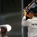 Race winner Nico Rosberg (GER) Mercedes AMG F1 and Lewis Hamilton (GBR) Mercedes AMG F1 celebrates with the trophy at Formula One World Championship, Rd19, Abu Dhabi Grand Prix, Race, Yas Marina Circuit, Abu Dhabi, UAE, Sunday 29 November 2015. © Sutton Motorsport Images