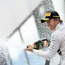 Nico Rosberg (GER) Mercedes AMG F1 celebrates with champagne on the podium at Formula One World Championship, Rd8, Austrian Grand Prix, Race, Spielberg, Austria, Sunday 21 June 2015. © Sutton Motorsport Images