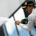 Race winner Nico Rosberg (GER) Mercedes AMG F1 celebrates in on the podium with the champagne at Formula One World Championship, Rd8, Austrian Grand Prix, Race, Spielberg, Austria, Sunday 21 June 2015. © Sutton Motorsport Images