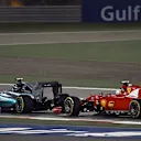 Nico Rosberg (GER) Mercedes AMG F1 W06 and Sebastian Vettel (GER) Ferrari SF15-T battle at Formula One World Championship, Rd4, Bahrain Grand Prix Race, Bahrain International Circuit, Sakhir, Bahrain, Sunday 19  April 2015. © Sutton Motorsport Images