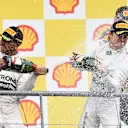 Race winner Lewis Hamilton (GBR) Mercedes AMG F1 and Nico Rosberg (GER) Mercedes AMG F1 celebrate on the podium with the champagne at Formula One World Championship, Rd11, Belgian Grand Prix, Race, Spa Francorchamps, Belgium, Sunday 23 August 2015. © Sutton Motorsport Images