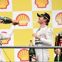 Race winner Lewis Hamilton (GBR) Mercedes AMG F1,  Nico Rosberg (GER) Mercedes AMG F1 and Romain Grosjean (FRA) Lotus F1 celebrate on the podium with the champagne at Formula One World Championship, Rd11, Belgian Grand Prix, Race, Spa Francorchamps, Belgium, Sunday 23 August 2015. © Sutton Motorsport Images
