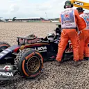 Marshals attend to Max Verstappen (NDL) Scuderia Toro Rosso STR10 after crashing into the gravel at Formula One World Championship, Rd9, British Grand Prix, Race, Silverstone, England, Sunday 5 July 2015. © Sutton Motorsport Images