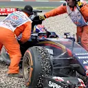 Marshals attend to Max Verstappen (NDL) Scuderia Toro Rosso STR10 after crashing into the gravel at Formula One World Championship, Rd9, British Grand Prix, Race, Silverstone, England, Sunday 5 July 2015. © Sutton Motorsport Images