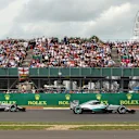 Nico Rosberg (GER) Mercedes AMG F1 W06 battles with Nico Hulkenberg (GER) Force India VJM08 and Lewis Hamilton (GBR) Mercedes AMG F1 W06 at the start of the race at Formula One World Championship, Rd9, British Grand Prix, Race, Silverstone, England, Sunday 5 July 2015. © Sutton Motorsport Images