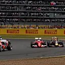 Sebastian Vettel (GER) Ferrari SF15-T and Daniil Kvyat (RUS) Red Bull Racing RB11 battle at Formula One World Championship, Rd9, British Grand Prix, Race, Silverstone, England, Sunday 5 July 2015. © Sutton Motorsport Images