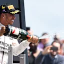 Race winner Lewis Hamilton (GBR) Mercedes AMG F1 celebrates on the podium with the champagne Formula One World Championship, Rd9, British Grand Prix, Race, Silverstone, England, Sunday 5 July 2015. © Sutton Motorsport Images