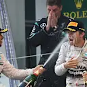 Lewis Hamilton (GBR) Mercedes AMG F1 and Nico Rosberg (GER) Mercedes AMG F1 celebrate on the podium with the champagne Formula One World Championship, Rd3, Chinese Grand Prix, Race, Shanghai, China, Sunday 12 April 2015. © Sutton Motorsport Images