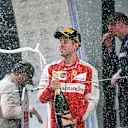 Sebastian Vettel (GER) Ferrari celebrates on the podium with the champagne at Formula One World Championship, Rd3, Chinese Grand Prix, Race, Shanghai, China, Sunday 12 April 2015. © Sutton Motorsport Images