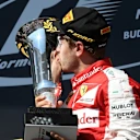 Race winner Sebastian Vettel (GER) Ferrari celebrates and kisses the trophy on the podium at Formula One World Championship, Rd10, Hungarian Grand Prix, Race, Hungaroring, Hungary, Sunday 26 July 2015. © Sutton Motorsport Images