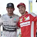 Race winner Lewis Hamilton (GBR) Mercedes AMG F1 and Sebastian Vettel (GER) Ferrari celebrate on the podium with the trophies at Formula One World Championship, Rd14, Japanese Grand Prix, Race, Suzuka, Japan, Sunday 27 September 2015. © Sutton Motorsport Images
