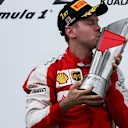 Race winner Sebastian Vettel (GER) Ferrari celebrates on the podium with the trophy at Formula One World Championship, Rd2, Malaysian Grand Prix, Race, Sepang, Malaysia, Sunday 29 March 2015. © Sutton Motorsport Images