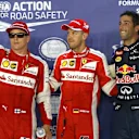 (L to R): Kimi Raikkonen (FIN) Ferrari, pole sitter Sebastian Vettel (GER) Ferrari and Daniel Ricciardo (AUS) Red Bull Racing celebrate in parc ferme at Formula One World Championship, Rd13, Singapore Grand Prix, Qualifying, Marina Bay Street Circuit, Singapore, Saturday 19  September 2015. © Sutton Motorsport Images