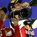 Race winner Sebastian Vettel (GER) Ferrari and Daniel Ricciardo (AUS) Red Bull Racing celebrate on the podium with champagne at Formula One World Championship, Rd13, Singapore Grand Prix, Race, Marina Bay Street Circuit, Singapore, Sunday 20 September 2015. © Sutton Motorsport Images