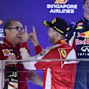 Race winner Sebastian Vettel (GER) Ferrari celebrates on the podium with Modesta Menabue (ITA) Ferrari Engine Specialist at Formula One World Championship, Rd13, Singapore Grand Prix, Race, Marina Bay Street Circuit, Singapore, Sunday 20 September 2015. © Sutton Motorsport Images