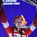 Race winner Sebastian Vettel (GER) Ferrari celebrates on the podium with the trophy at Formula One World Championship, Rd13, Singapore Grand Prix, Race, Marina Bay Street Circuit, Singapore, Sunday 20 September 2015. © Sutton Motorsport Images