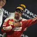 Sebastian Vettel (GER) Ferrari celebrates on the podium with the trophy at Formula One World Championship, Rd21, Abu Dhabi Grand Prix, Race, Yas Marina Circuit, Abu Dhabi, UAE, Sunday 27 November 2016. © Sutton Images