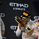 New World Champion Nico Rosberg (GER) Mercedes AMG F1 celebrates on the podium with Lewis Hamilton (GBR) Mercedes AMG F1 and the trophy at Formula One World Championship, Rd21, Abu Dhabi Grand Prix, Race, Yas Marina Circuit, Abu Dhabi, UAE, Sunday 27 November 2016. © Sutton Images