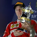 Kimi Raikkonen (FIN) Ferrari celebrates on the podium with the trophy at Formula One World Championship, Rd2, Bahrain Grand Prix Race, Bahrain International Circuit, Sakhir, Bahrain, Sunday 3 April 2016. © Sutton Motorsport Images