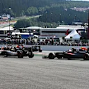 Sergio Perez (MEX) Force India VJM09 and Jenson Button (GBR) McLaren MP4-31 run wide at the start of the race at Formula One World Championship, Rd13, Belgian Grand Prix, Race, Spa Francorchamps, Belgium, Sunday 28 August 2016. © Sutton Images