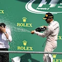 Lewis Hamilton (GBR) Mercedes AMG F1 and Hywel Thomas (GBR) Mercedes AMG F1 celebrate on the podium with the champagne at Formula One World Championship, Rd13, Belgian Grand Prix, Race, Spa Francorchamps, Belgium, Sunday 28 August 2016. © Sutton Images