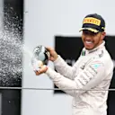 Lewis Hamilton (GBR) Mercedes AMG F1 celebrates with the champagne on the podium at Formula One World Championship, Rd20, Brazilian Grand Prix, Race, Interlagos, Sao Paulo, Brazil, Sunday 13 November 2016. © Sutton Images